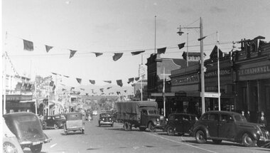 Photograph - Upper Main Street looking West, Upper Main Street with Bunting looking West & Named Shops in 2nd Photo -- 2 Photos