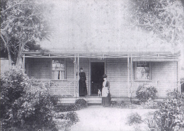 Photograph, Mrs Kinsella ? In front of weatherboard home