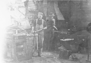 Photograph, Mr Percy Ledger on the left at the Blacksmith shop with Forge Anvil and Vice