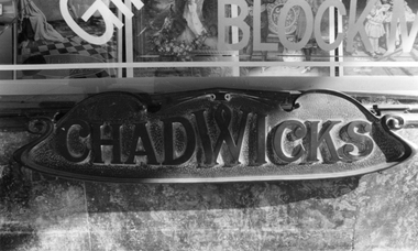 Photograph, Bronze inscription at the base of the Main Display window of Drapery business by Mr Josef. Chadwick