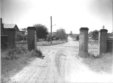 Photograph, Stawell Cemetery looking from inside through the gates up Barnes Street
