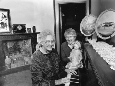 Photograph, Pleasant Creek Court House with Stawell Historical Society President Margaret Mason at the Piano & Treasurer Mari Van Leeuwen with the doll 1989