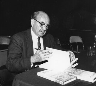 Photograph, Shepherd’s Gold Book with its Author Mr C E Sayers signing copies 1966