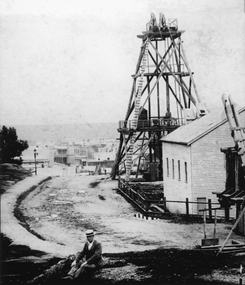Photograph, Sloane's & Scotchman Mining Co Poppet Head in Upper Main Street Big Hill looking West. c1890
