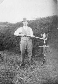 Photograph, Mr Sydney Davidson standing with shotgun and trophy