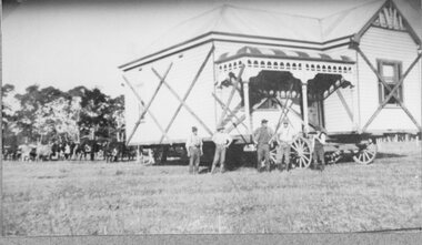 Photograph, Freeland Contractors shifting a wooden home with a Bullock Team