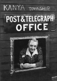 Photograph, Mrs Catherine Agnes Davies looking out serving window of Kanya Post Office c1950's