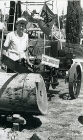 Photograph, Mr Peter Gellert sawing a tree using a Motorised saw