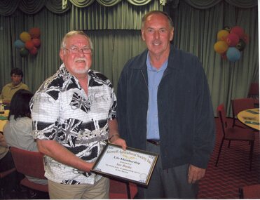 Photograph, Mr Ian Burke receiving Life Membership Certificate from Show President Geoff Erwin -- Coloured