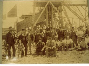 Photograph, Unknown mine with group of men in foreground and poppet head in background