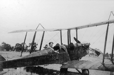 Photograph, Mr Bob McClure at controls of a Biplane 1920
