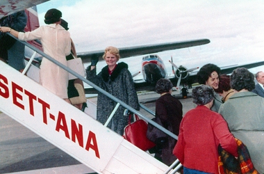 Photograph, Gwen Boisen waving as boarding a Anset ANA plane