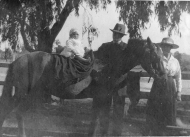 Photograph, Man and woman with child on top of a horse going to church  1940's