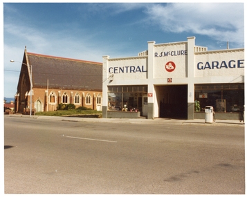 Photograph, Pleasant Creek Special School, Anglican Holy Trinity Church of England, R J McClure Central Garage with petrol Bowsers out front -- Nov 1975, Nov 1975