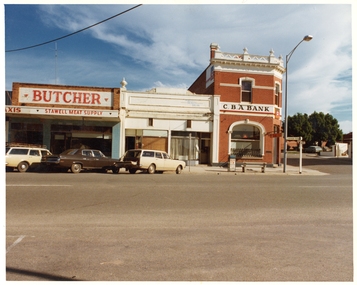 Photograph, Pleasant Creek Special School, Bates Taxi Service, Dave Young Butcher, Curly Halls Fruit & Veggies with Pamelas Hair Saloon & Commercial Bank Nov 1975, Nov 1975