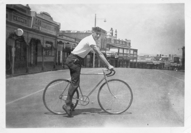 Photograph, Mr Alan Tangey on a Bicycle in Upper Main Street 1947