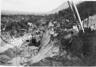 Photograph, Heatherlie Quarry with crane on right and cut blocks at bottom of cliff face
