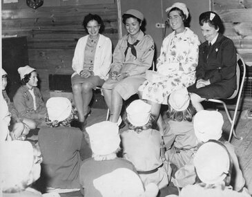 Photograph, Group leaders some in Guide Uniform Seated in front of Guides
