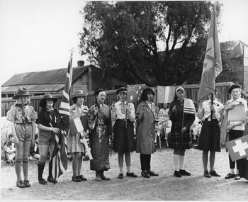 Photograph, Group of Stawell Guides some in dress up making pledge with flags