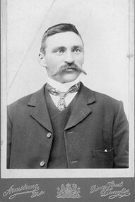 Photograph, Portrait of gentleman in suite with large handlebar mustache
