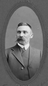 Photograph, Portrait of gentleman in suite with handlebar mustache