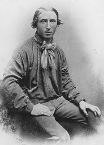 Photograph, Studio portrait of seated young man in striped shirt and bow tie