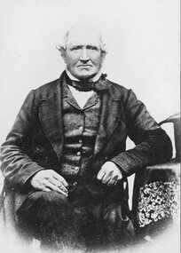 Photograph, Studio portrait of older seated man in dark suite