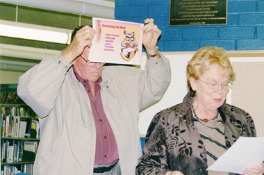 Photograph, Two people in library presentation