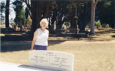 Photograph, A Woman Standing Behind Headstone