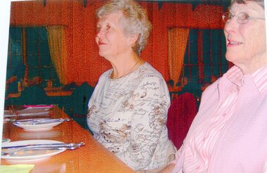 Photograph, Two People Seated behind a table