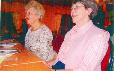 Photograph, Two People Seated behind a table