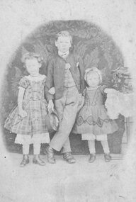Photograph, Carte-de-Visite photo of Boy posing with two younger girls for studio portrait. c1880