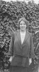 Photograph, Agnes Cragg in front of hedge