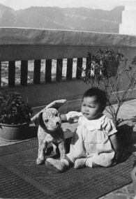 Photograph, Baby Anna Goh one year old with a toy dog on balcony - Anna Goh Collection