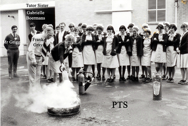 Fire Drill: Frank Gray demonstrating, left Mr L Grigg engineer & Senior Tutor Miss G Boermans - PTS 19?