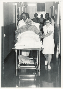Q1 or QG, Mr Hadden Porter - patient, Sr Tubb in background, Mr Bridger, Mrs E Robinson, ?1980