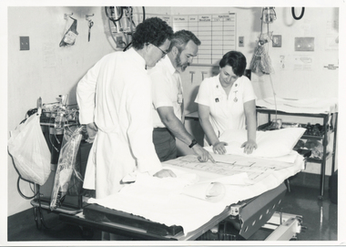 Dr M Fitzgerald- Director of Medical A&E, Dr C B E Davis - Director of Medical Services, Sr Judy Lindsay, examine plans for A&E renovation