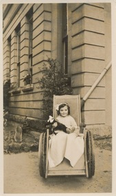 Polio child wheelchair, Edward Wilson, ? Front of 8,9,10