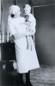 Beth Cuthbertson, commenced training 1929 - holding Jim Kinnersly, diphtheria patient BBH