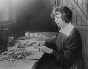 Photograph - Sadie Pemberton packaging various fireworks at the Phoenic Fireworks Factory, 1940