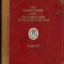 A red book with brown leather corners and spine and gilt lettering on the cover