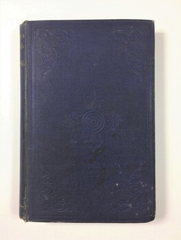 Blue cloth covered book with debossed scrollwork in each corner and in the centre. There are some areas of dark staining from age and use.