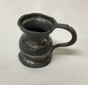 Small pewter measure for a tot of rum, shaped like a flagon, with a handle.  From SS Lady Loch,  Tasmanian lighthouse tender.