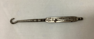 Metal button hook, advertising Nugget shoe polishes