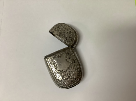 Small sterling silver embossed match container with a hinged lid. Embossed leaves and shield design. 