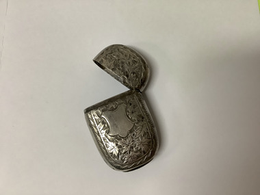 Small sterling silver embossed match container with a hinged lid. Embossed leaves and shield design. 