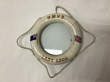 Picture frame shaped as a life buoy, with  rope decoration, under glass, decorated with the Australian and UK flags. Souvenir of the Lady Loch. 
