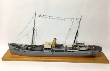 Ship model - of the steam ship “Lady Loch”, painted grey, red below waterline, two masts, rattlins on side shrouds, single funnel, two lifeboats port and starboard, varnished bridge coach house, boom on foremast, anchor catted at bow port and starboard, radio aerials strung between masts.