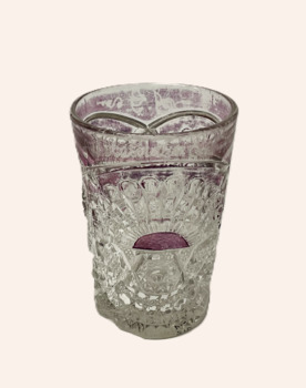 Souvenir pressed glass drinking glass, with a rising sun design and ruby coloured highlights.