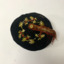 Man’s soft black cotton smoking cap with white, red and green holly embroidery and tassel.